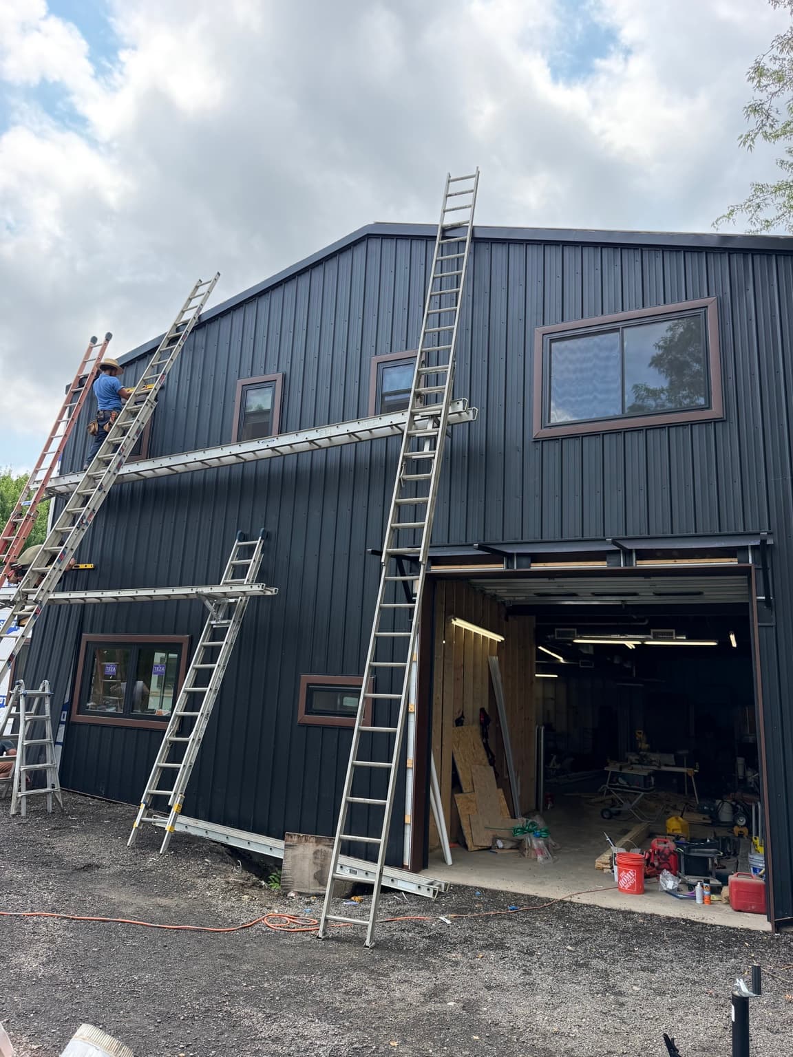 Vertical metal siding installation at the front facade