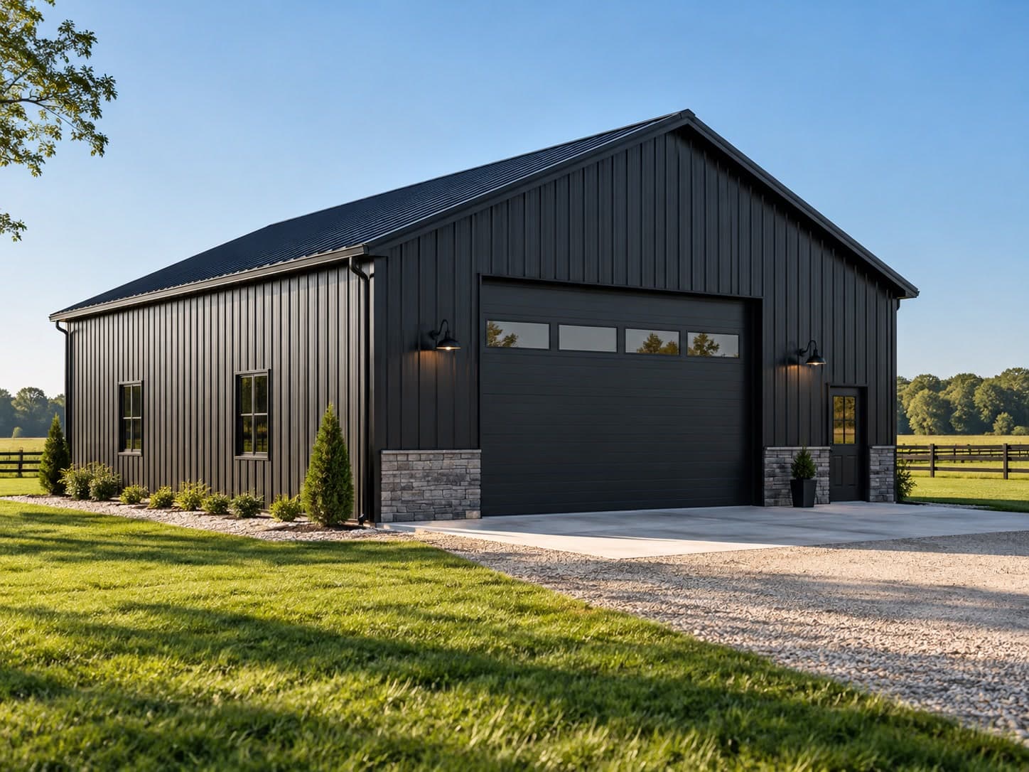 Black board-and-batten metal pole building with stone wainscoting and garage door
