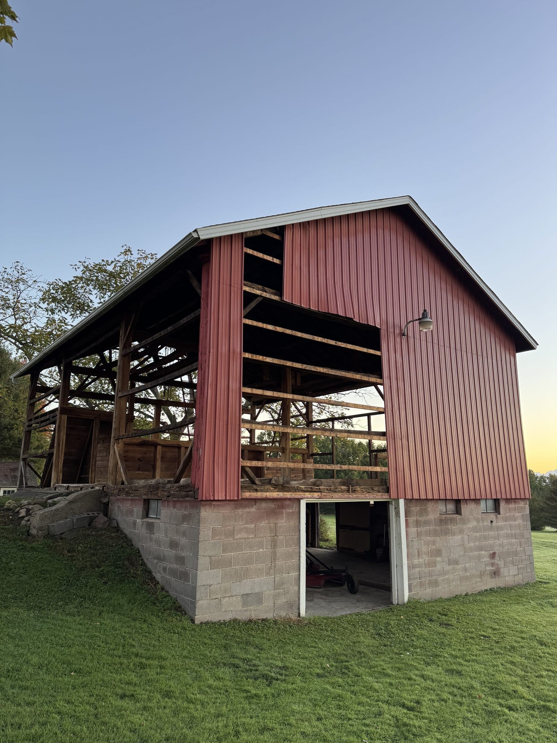 Red metal barn exterior before the siding renovation